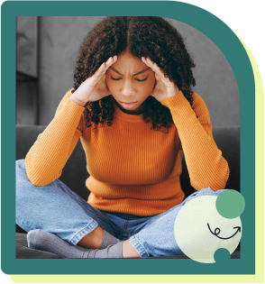 Woman sitting with head in her hands